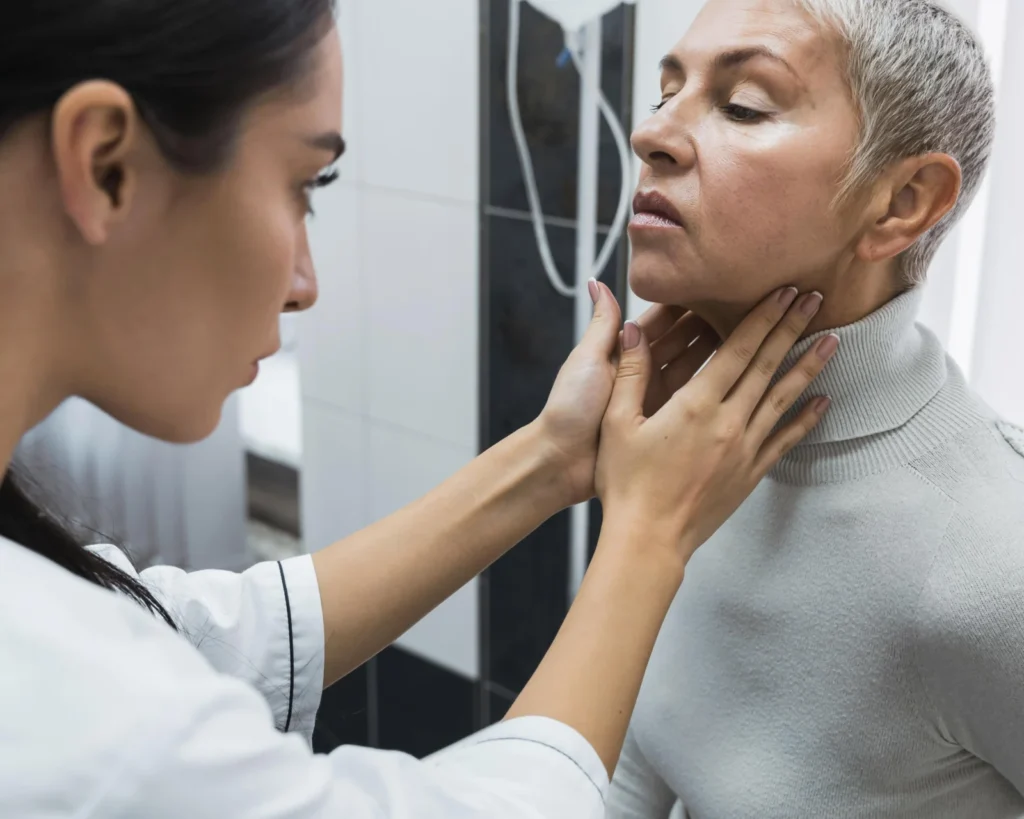 Médica examinando o pescoço de uma paciente (imagem ilustrativa)